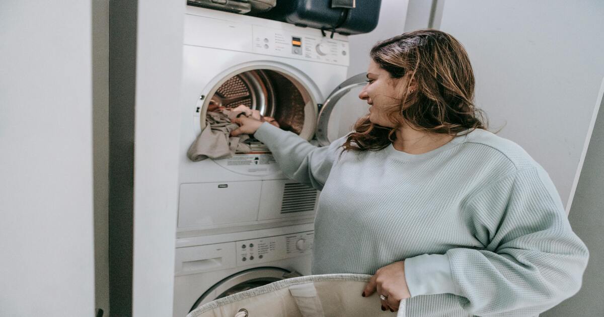 A woman washing flannel sheets. 