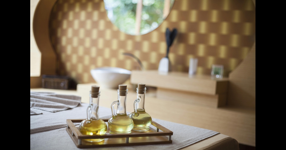 Three unopened bottles of essential oil on a tray.